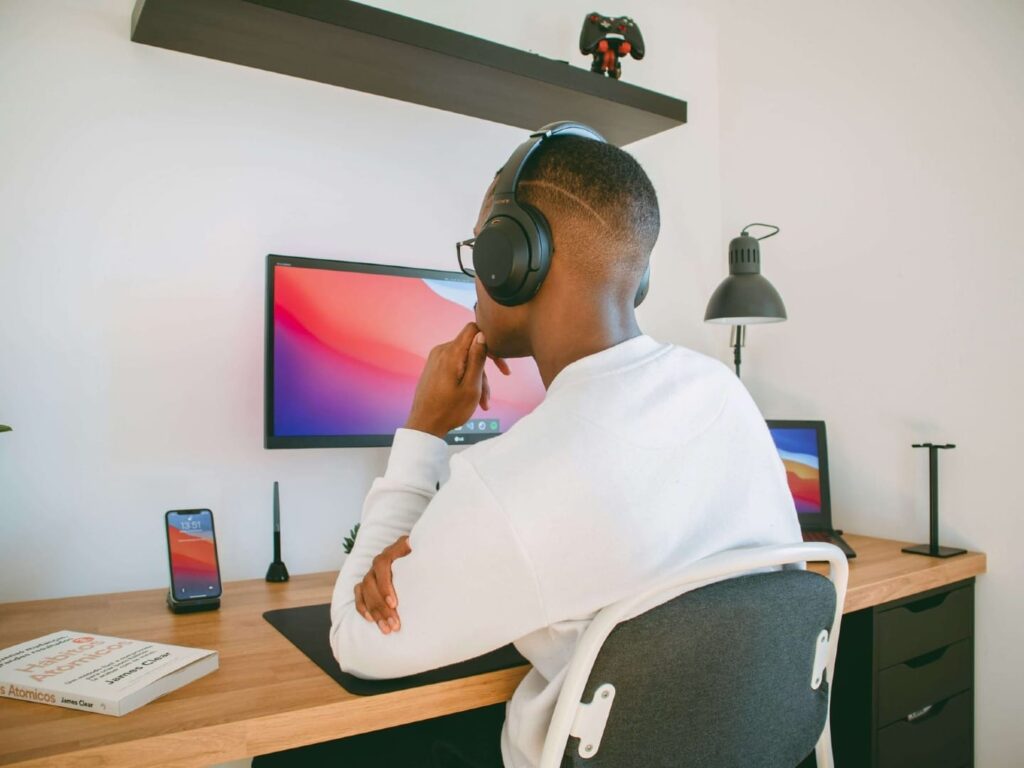 Buffer AI assistant interface rephrasing a post about working from home as a parent, with preview shared across multiple social media accounts and attached workspace photos.