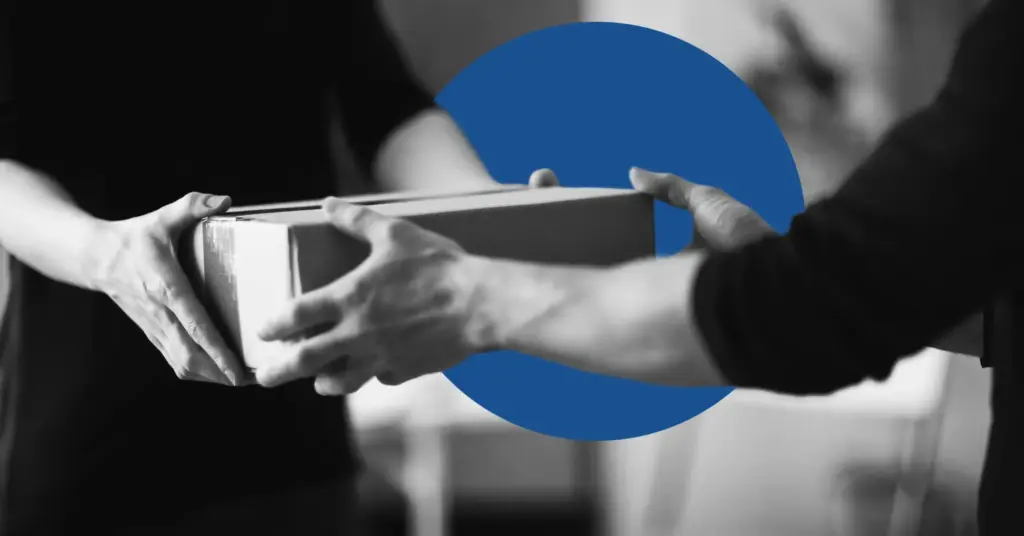A package changes hands in black and white to illustrate the idea of deliverability in email.