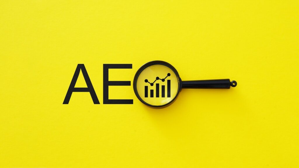 Illustration of AEO font on yellow background with a magnifying glass.